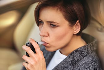 A Young lady measuring the levels of alcohol in blood